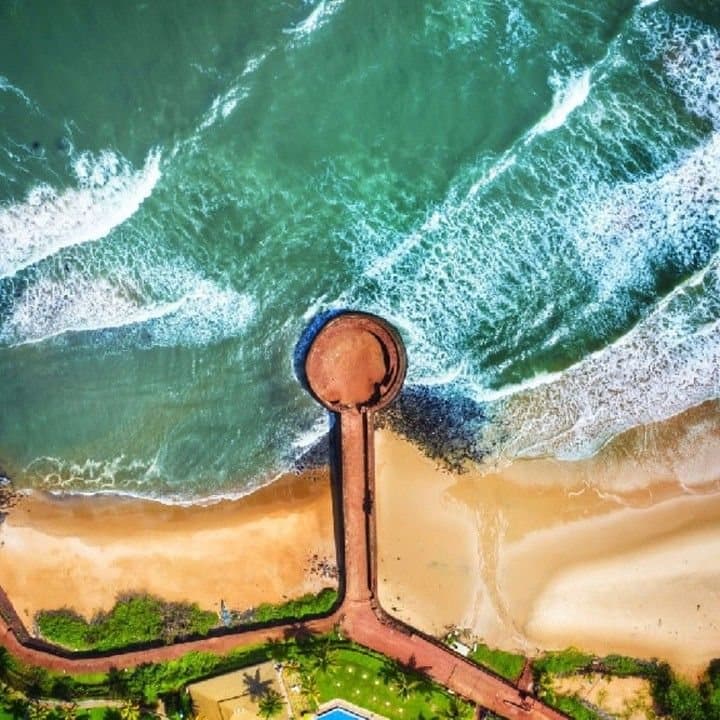 The North Goa coast from the air, surf breaking along the headland