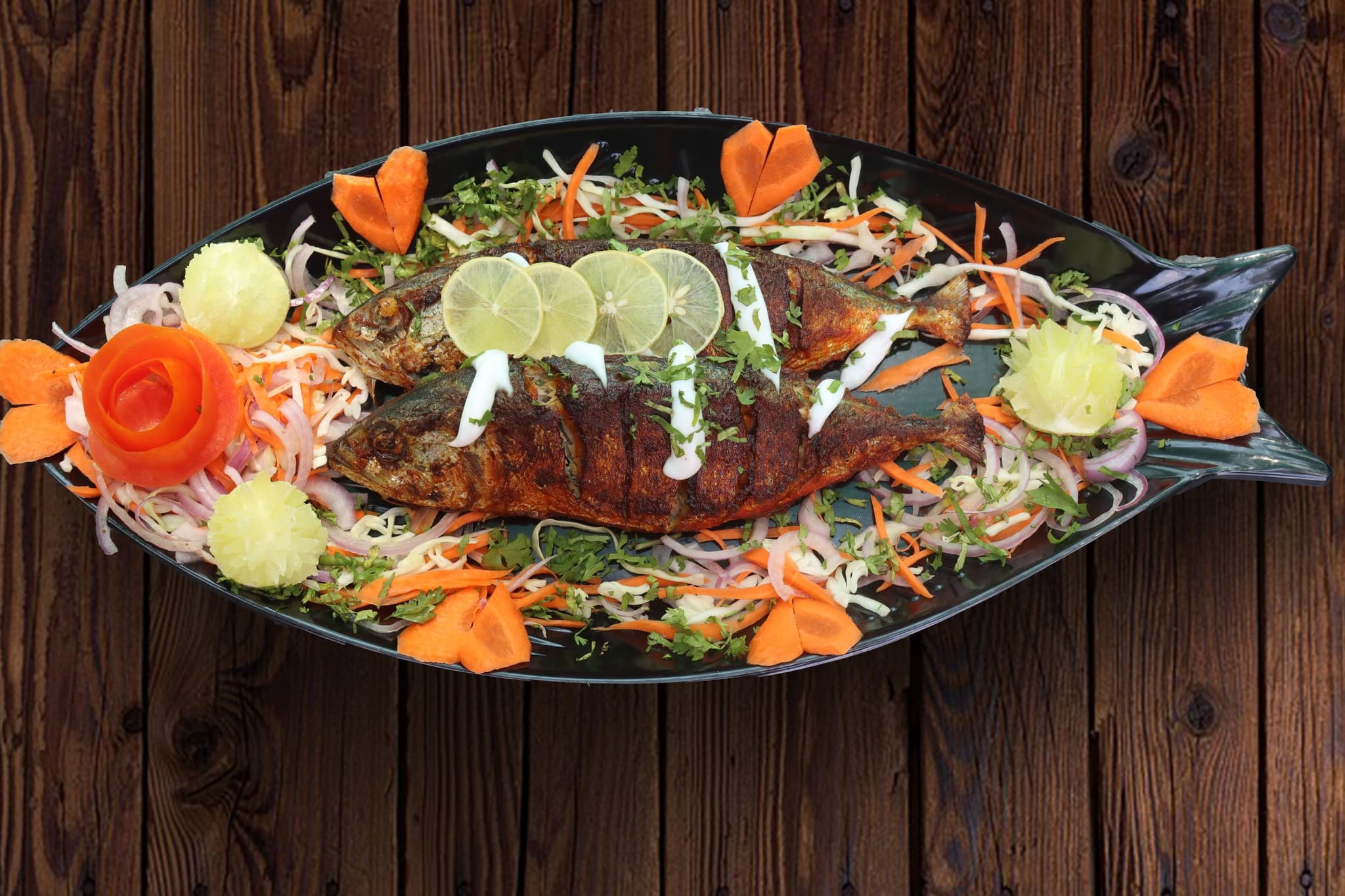 A whole fish, dressed and plated Goan-style